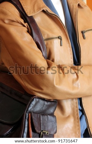 mannequin wearing casual leather coat and purse