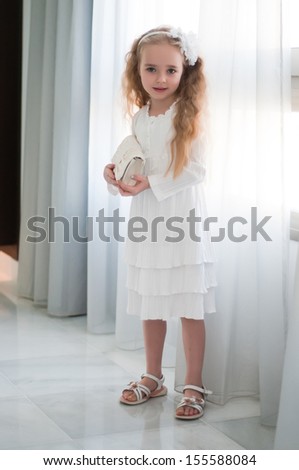 Portrait of beautiful girl near white curtain
