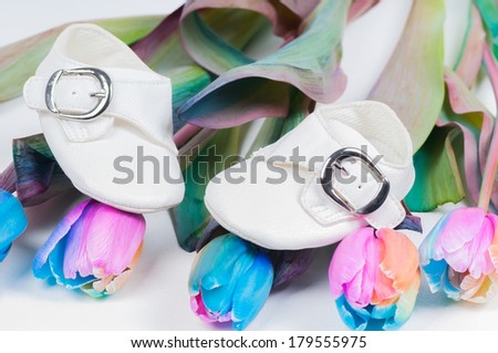 Baby shoes and unusual multi colored tulips