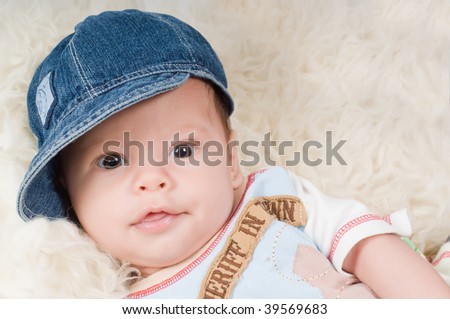 Shot of trendy newborn boy in denim cap