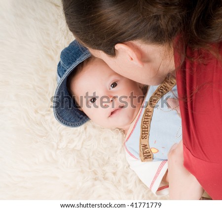 Shot of trendy newborn boy in denim cap