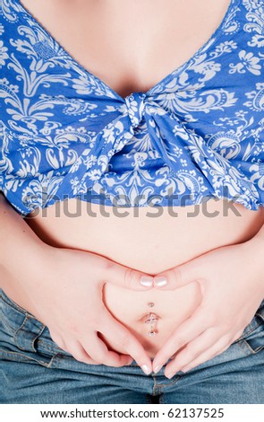 Pregnant woman hands in form of heart sign