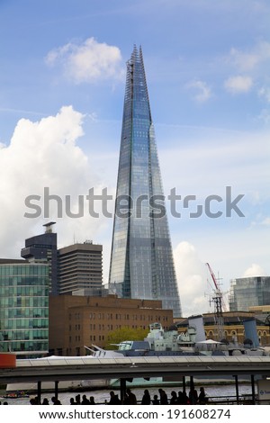 LONDON, UK - APRIL 24, 2014: Shard of glass on the river Thames, office and residential building in the City of London one of the leading centres of global finance.