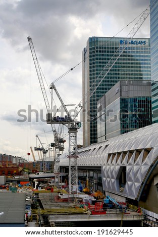 LONDON, UK - APRIL 24, 2014: Building site with cranes Canary Wharf aria, one of the leading centres of global finance, headquarters for leading banks, insurance, stock exchange, media businesses