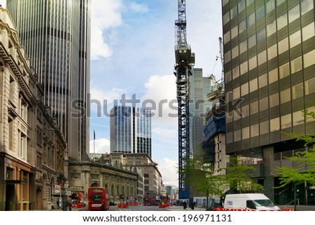 LONDON, UK - APRIL 24, 2014: Building site with cranes in the City of London one of the leading centres of global finance.