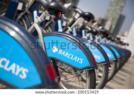 LONDON, UK - MAY 7, 2014: Boris bikes parking on business Canary Wharf aria, sponsored by Barkley\'s bank. Popular city transport among Londoners