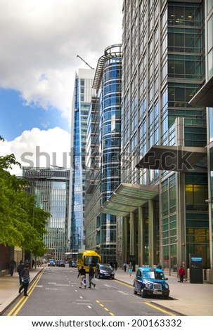 LONDON, UK - MAY 14, 2014: Modern glass architecture of Canary Wharf aria the leading centre of global finance, banking, media, insurance etc. Office buildings