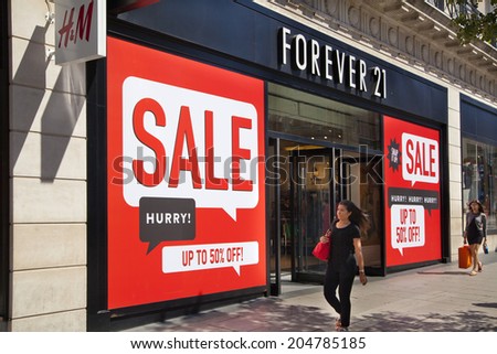 LONDON, UK - JULY 03, 2014: Sale sign on Oxford street shopping mail with famous fashion boutiques and super stors