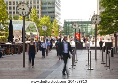 LONDON, UK - JULY 03, 2014: People blur. Office people moving fast to get to work at early morning in Canary Wharf aria