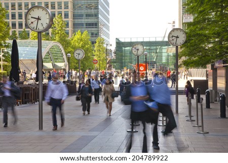 LONDON, UK - JULY 03, 2014: People blur. Office people moving fast to get to work at early morning in Canary Wharf aria