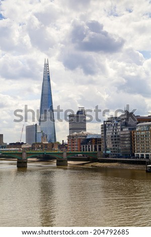 LONDON, UK - JUNE 30, 2014: Shard of glass on the river Thames, office and residential building in the City of London one of the leading centres of global finance.