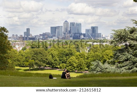 LONDON UK - JULY 28, 2014: View on business district Canary Wharf from old English park, south of London