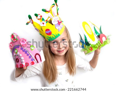 Little girl demonstrating her cruft work Easter bonnets