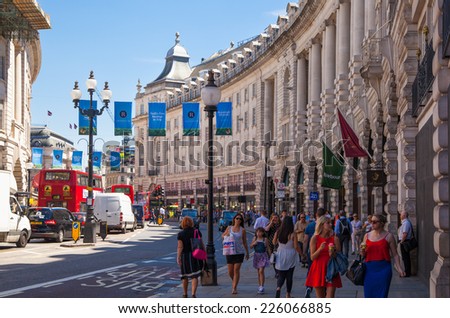 LONDON, UK - SEPTEMBER 30, 2014: People and traffic in Piccadilly Circus in London. Famous place for romantic dates.Square was built in 1819 to join of Regent Street