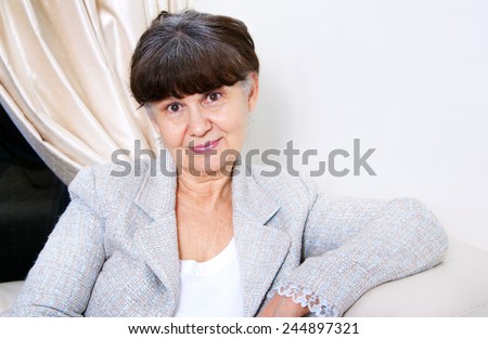 Pension age good looking woman portrait in domestic environment