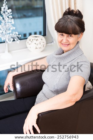 Pension age good looking woman portrait in domestic environment