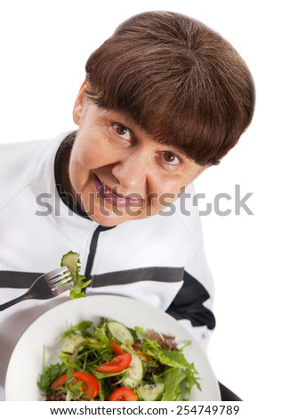 Pension age woman in sport costume with salad. Healthy life style concept
