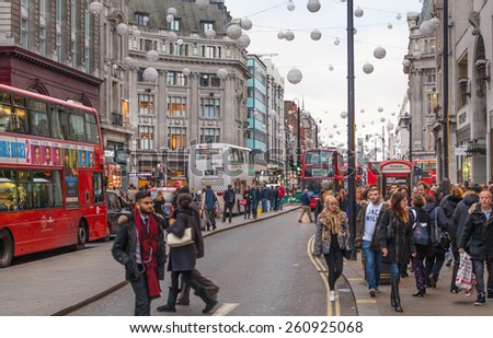 LONDON, UK - NOVEMBER 30, 2014: Regent street, Oxford circus with lots of pedestrians and cars, taxis on the road.