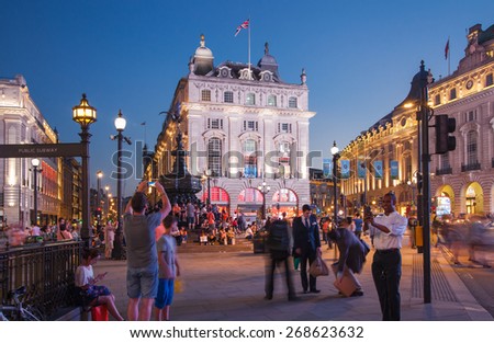 LONDON, UK - AUGUST 22, 2014: Piccadilly Circus in night. Famous place for romantic dates. Square was built in 1819 to join of Regent Street
