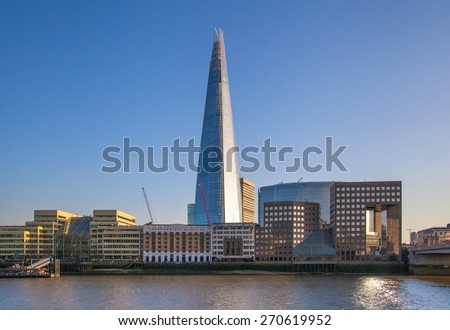 LONDON, UK - APRIL 15, 2015: Shard of glass in sunset. Panoramic view of south bank river Thames walk.
