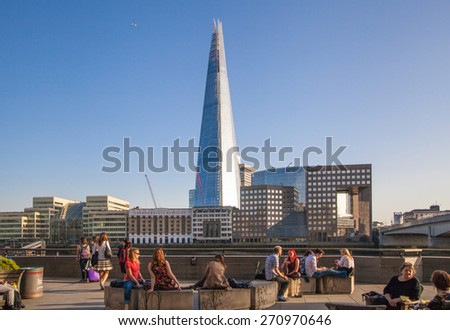 LONDON, UK - APRIL15, 2015: Shard of glass in sunset. Panoramic view of south bank river Thames walk.