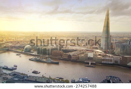 LONDON, UK - APRIL 22, 2015: City of London panorama in sunset. Shard of glass and river Thames