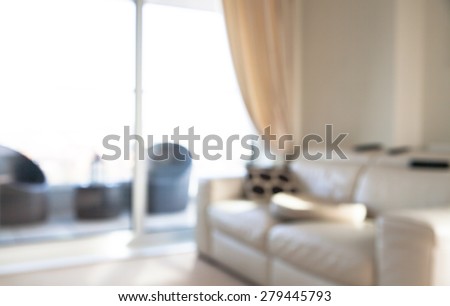 Interior blur background. Living room with big window, sofa, tree