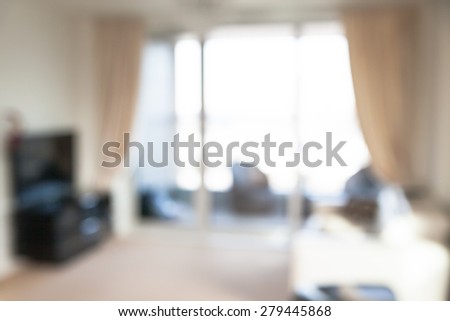 Interior blur background. Living room with big window, sofa, tree