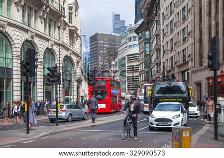 LONDON, UK - APRIL 22, 2015: City of London street view with buses and cars