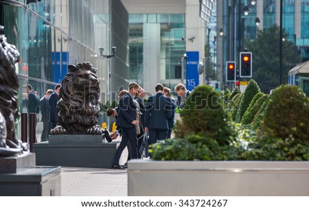 LONDON, UK - SEPTEMBER 14, 2015:  Office workers going at work. Early morning hours in Canary Wharf business life