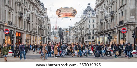 LONDON, UK - NOVEMBER 30, 2014: Regent street, Oxford circus with lots of pedestrians and cars, taxis on the road.