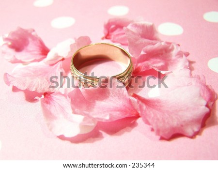 stock photo wedding ring petals and pink background