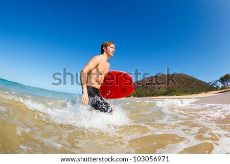 Young Man with Boogie Board at the Beach