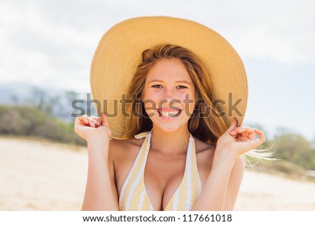 Smiling Beautiful Woman at the Beach in Sun Hat