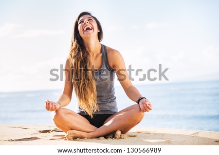 Young woman practicing morning meditation in nature at the beach