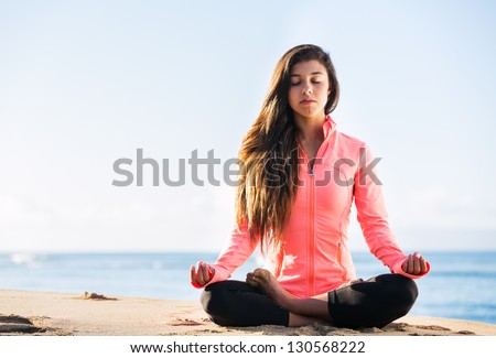 Young Woman Practicing Morning Meditation In Nature At The Beach