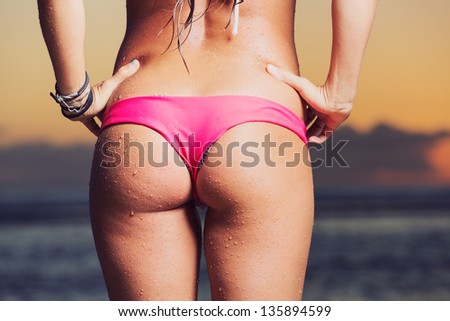 young sexy woman in bikini at the beach, thong bikini
