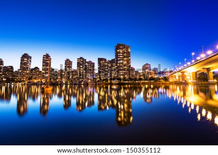 Modern Urban City Skyline Reflecting in Water at Sunset, Vancouver
