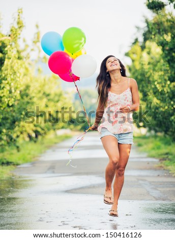 Beautiful Happy Girl Holding Balloons