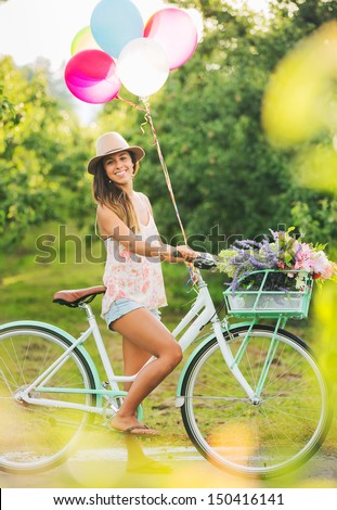 Beautiful Girl on Bike with Balloons in Countryside, Summer Lifestyle