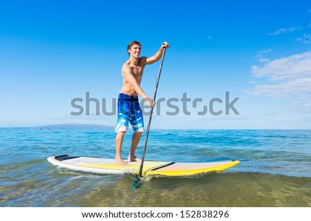 Attractive Man on Stand Up Paddle Board, SUP, Tropical Blue Ocean, Hawaii