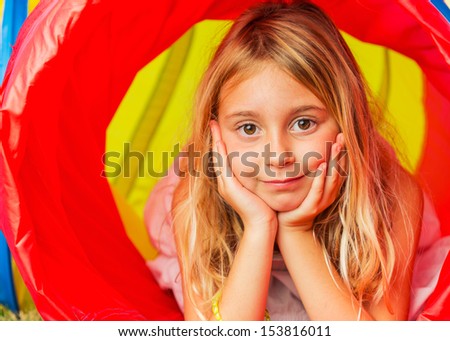 Cute Young Girl Playing Outside in Colorful Tunnel