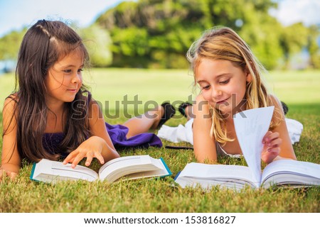 Cute Little Girls Reading Books Outside, Friendship and Learning Concept