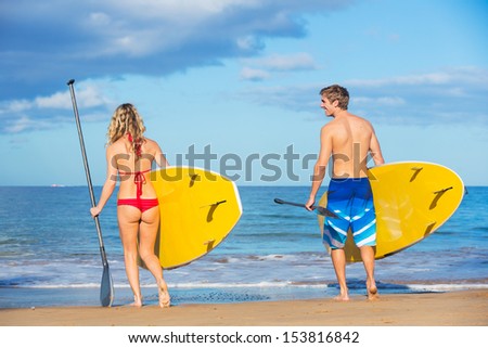 Attractive Couple Stand Up Paddling in Hawaii, Active Life Concept