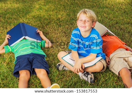 Group of Happy Kids Reading Books Outside, Friendship and Learning Concept