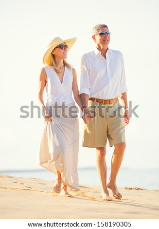 Happy Romantic Middle Aged Couple Enjoying Walk on the Beach, Vacation Retirement Concept