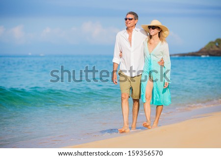 Happy Romantic Couple Walking on the Beach Happy Romantic Couple Walking on the Beach