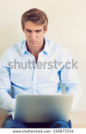 Young Professional, Handsome Man Working on Laptop Computer
