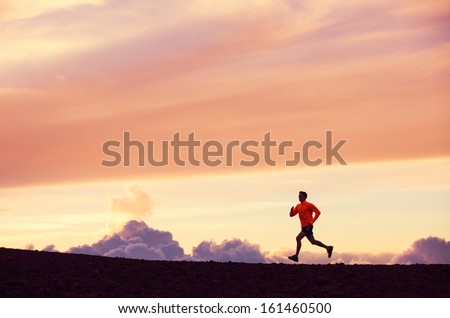 Male runner silhouette, Man running into sunset, colorful sunset sky