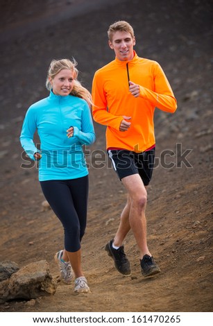 Fitness sport couple jogging outside, training together outdoors. Running on nature trail